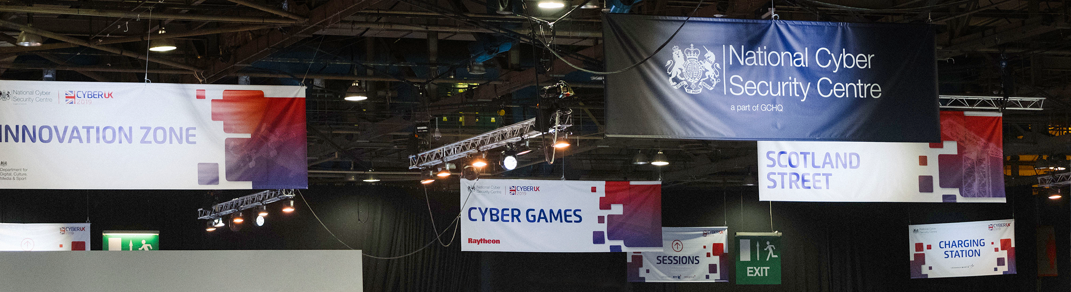 Directive banners hanging from ceiling at previous CYBERUK event